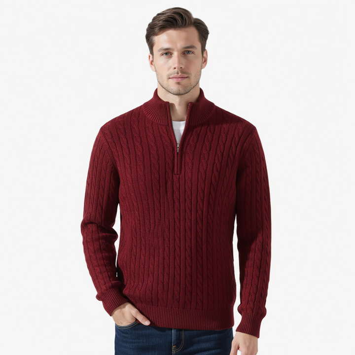 Man wearing a red cable knit sweater on a white background