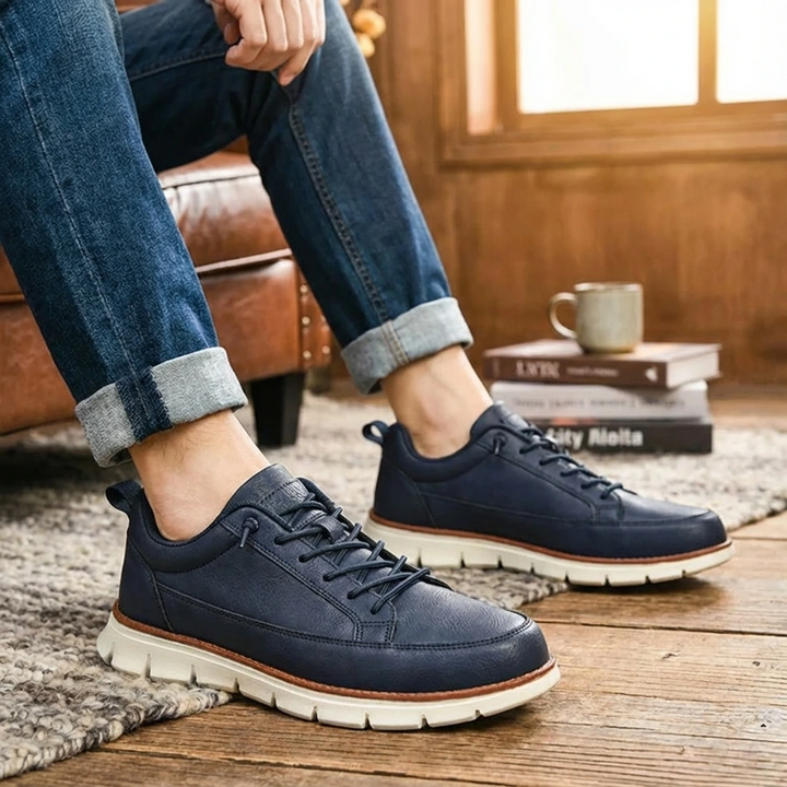 Person wearing navy blue sneakers with white soles.
