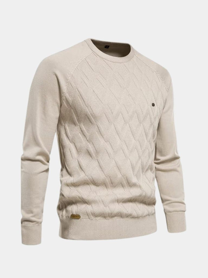 Beige cable knit sweater on a light gray background