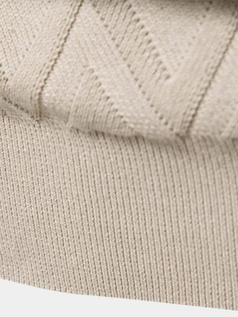 Close-up of beige knitted fabric texture