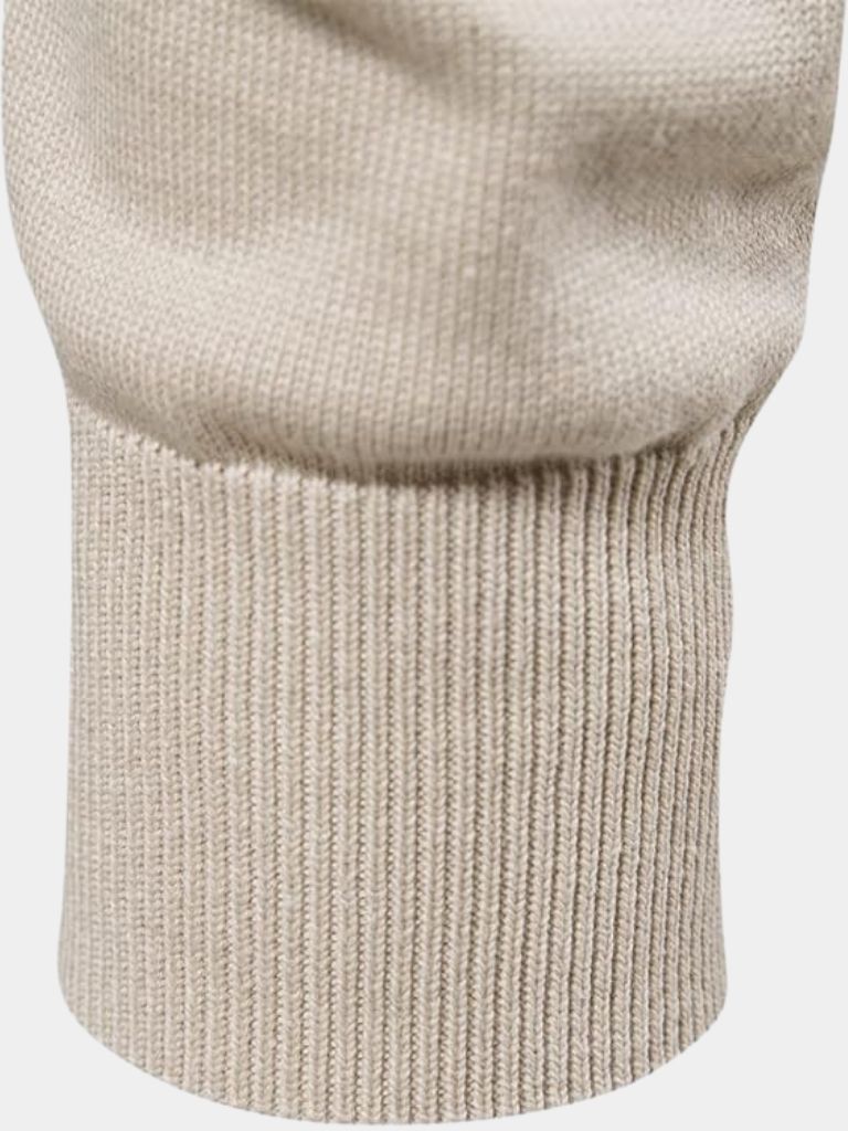 Close-up of a beige knitted sweater on a white background